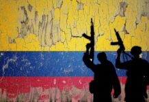 Silhouettes of armed individuals against a weathered Colombian flag background