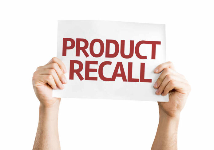 Hands holding a sign that reads 'PRODUCT RECALL'