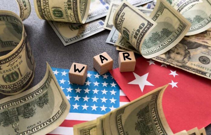 Dollar bills surrounding wooden blocks spelling 'WAR' on flags of the USA and China