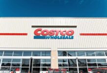 Exterior view of a Costco Wholesale store with shopping carts in front