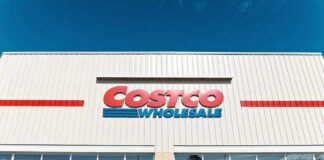 Exterior view of a Costco Wholesale store with shopping carts in front