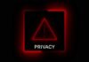 A red neon privacy warning sign with an exclamation mark