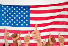 TrumpRx Scores Another Victory Thumbs up in front of American flag.