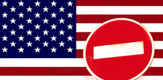 A no entry sign in front of the American flag
