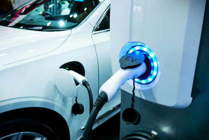 Electric vehicle charging at a station, close-up view.