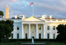 The White House with Washington Monument in background.