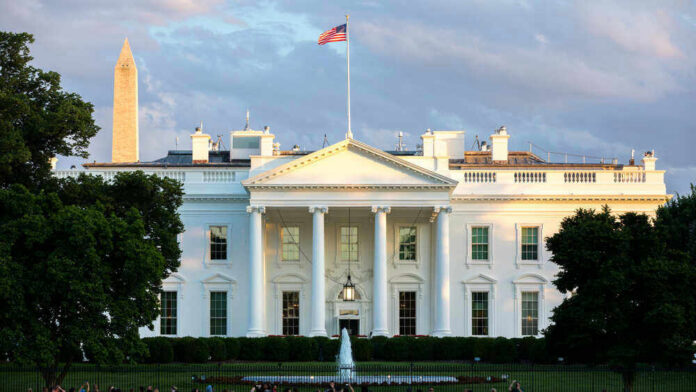 The White House with Washington Monument in background.