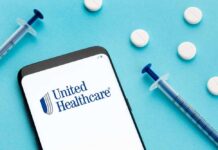 Mobile phone displaying United Healthcare logo with syringes and pills on a blue background