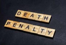 Death Penalty PUSH – Shocking Murders Involved Wooden letter tiles spelling DEATH PENALTY on a dark background