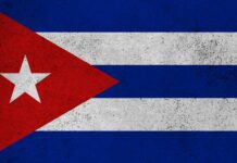 Cuban flag featuring red triangle, white stripes, and a star