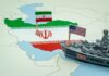 A map of Iran with flags of Iran and the United States and a toy military ship
