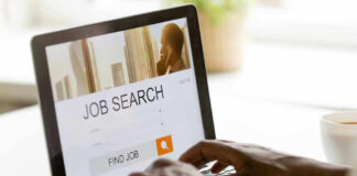 Person searching for jobs on a laptop.