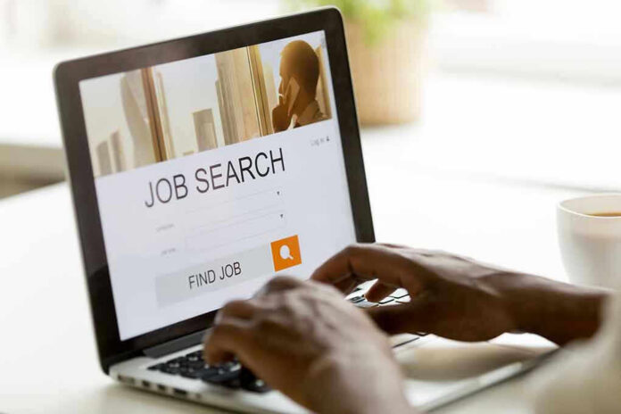Person searching for jobs on a laptop.