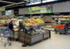 People shopping and cleaning inside an Aldi supermarket.