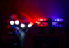 Police car lights shining in the dark.