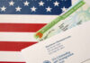 Permanent resident card and official letter on an American flag background
