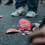 Shattered Make America Great Again hat on the ground