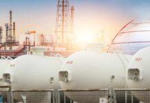 Gas storage tanks in an industrial facility during sunrise