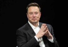 Elon Musk in a suit talking.