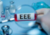 Magnifying glass over test tube labeled EEE