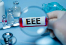 Magnifying glass over test tube labeled EEE