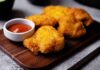 Crispy fried chicken pieces served with a small bowl of ketchup