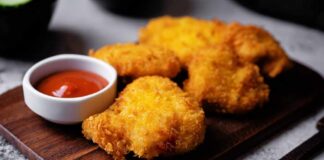 Crispy fried chicken pieces served with a small bowl of ketchup