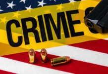 Teen Ghost Gun Carnage at Space Needle A gun and bullets on an American flag with a crime scene marker