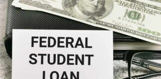 A sign reading 'Federal Student Loan' next to a stack of money and a pen