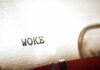 Woke Rebrand Backfires — CEO Out Close-up of the word WOKE typed on paper from a typewriter