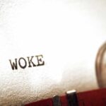 Close-up of the word WOKE typed on paper from a typewriter