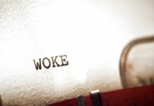 Close-up of the word WOKE typed on paper from a typewriter
