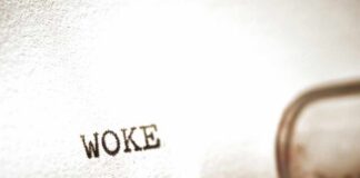 Close-up of the word WOKE typed on paper from a typewriter