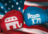 Red and blue boxing gloves with political party symbols.