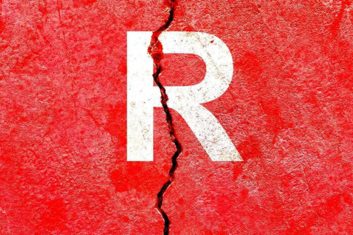 shutterstock_2222197027 Cracked red wall with white letter R.