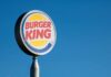 Fast-food restaurant sign against a clear blue sky