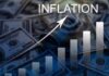 Inflation Dips — Wallets Still Scream A visual representation of inflation with dollar bills and a rising graph