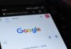 Close-up of a smartphone displaying the Google search homepage