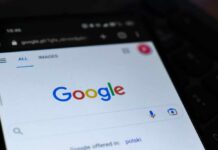 Close-up of a smartphone displaying the Google search homepage