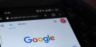 Close-up of a smartphone displaying the Google search homepage