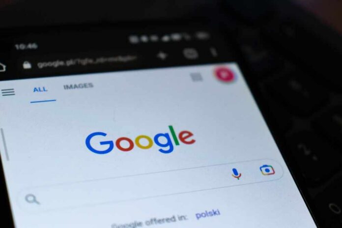 Close-up of a smartphone displaying the Google search homepage