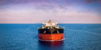 Oil tanker ship on open sea at dusk