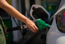 Gas Hits $4 — The Real Culprit Hiding Person refueling a car at a gas station