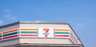 Exterior view of a 7-Eleven convenience store under a clear blue sky