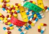 $50 Weight-Loss Tease — Who Actually Qualifies? Colorful capsules scattered with a measuring tape