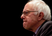 Bernie Sanders’ AI Power Grab Sparks Firestorm Bernie Sanders in glasses.