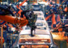 Robotic arms welding car bodies in an automotive factory.