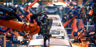 Robotic arms welding car bodies in an automotive factory.
