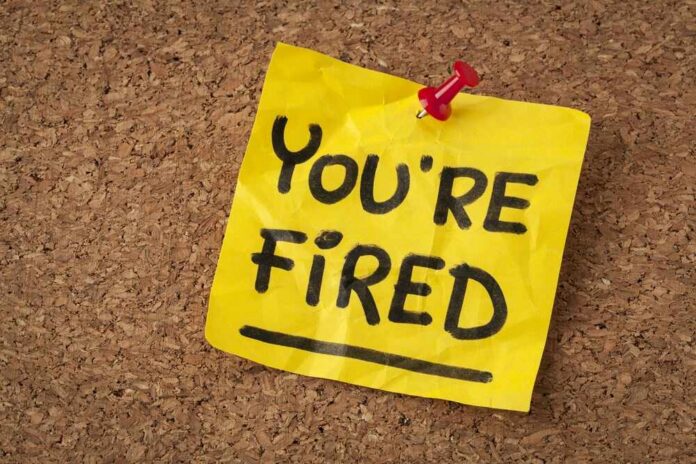 shutterstock_143982457 A yellow sticky note pinned to a corkboard with the words 'YOU'RE FIRED' written on it