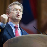 US Senator Rand Paul giving a passionate speech with fist raised.